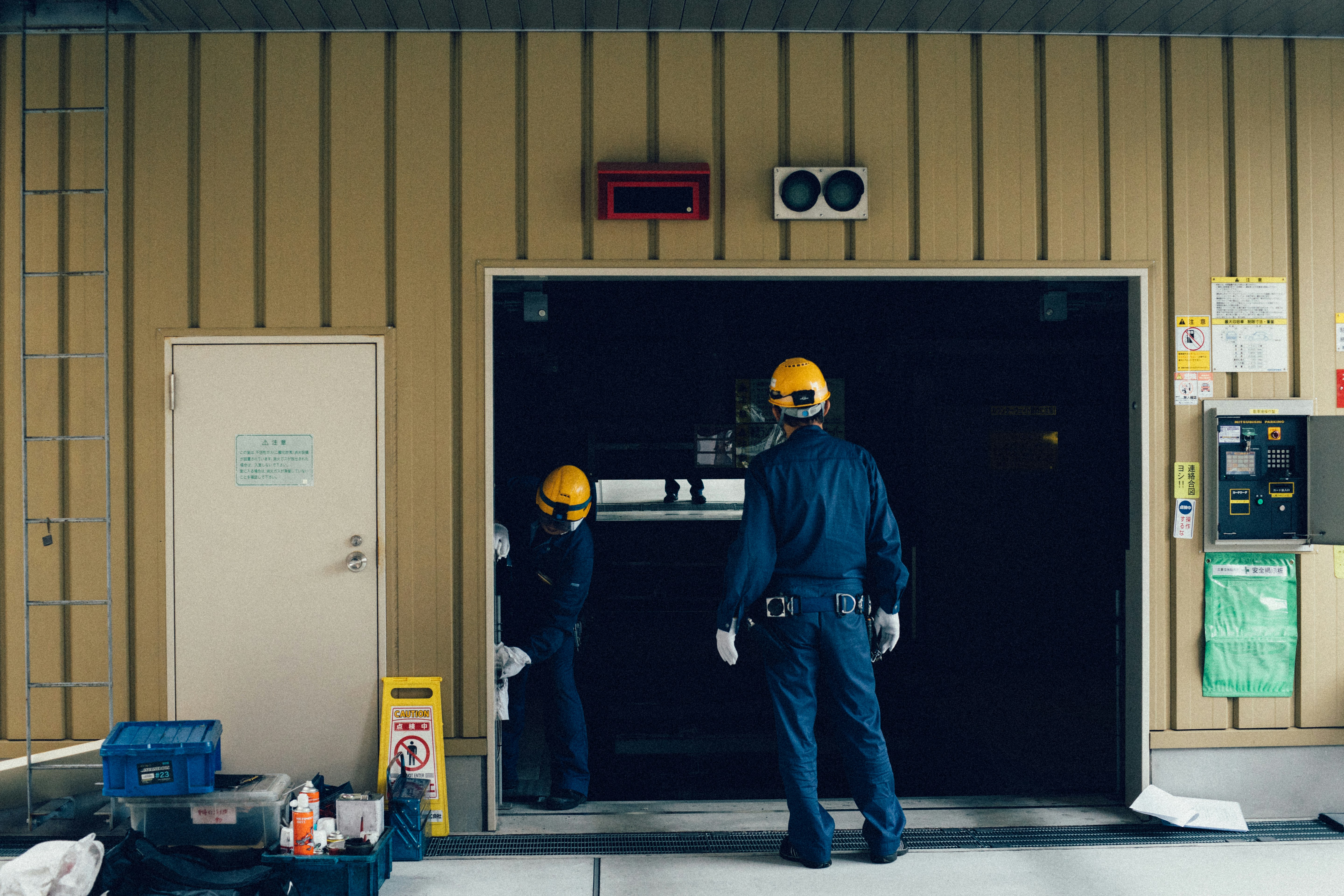 Technician repairing a garage door in a residential garage, focusing on fixing mechanical components for smooth operation.